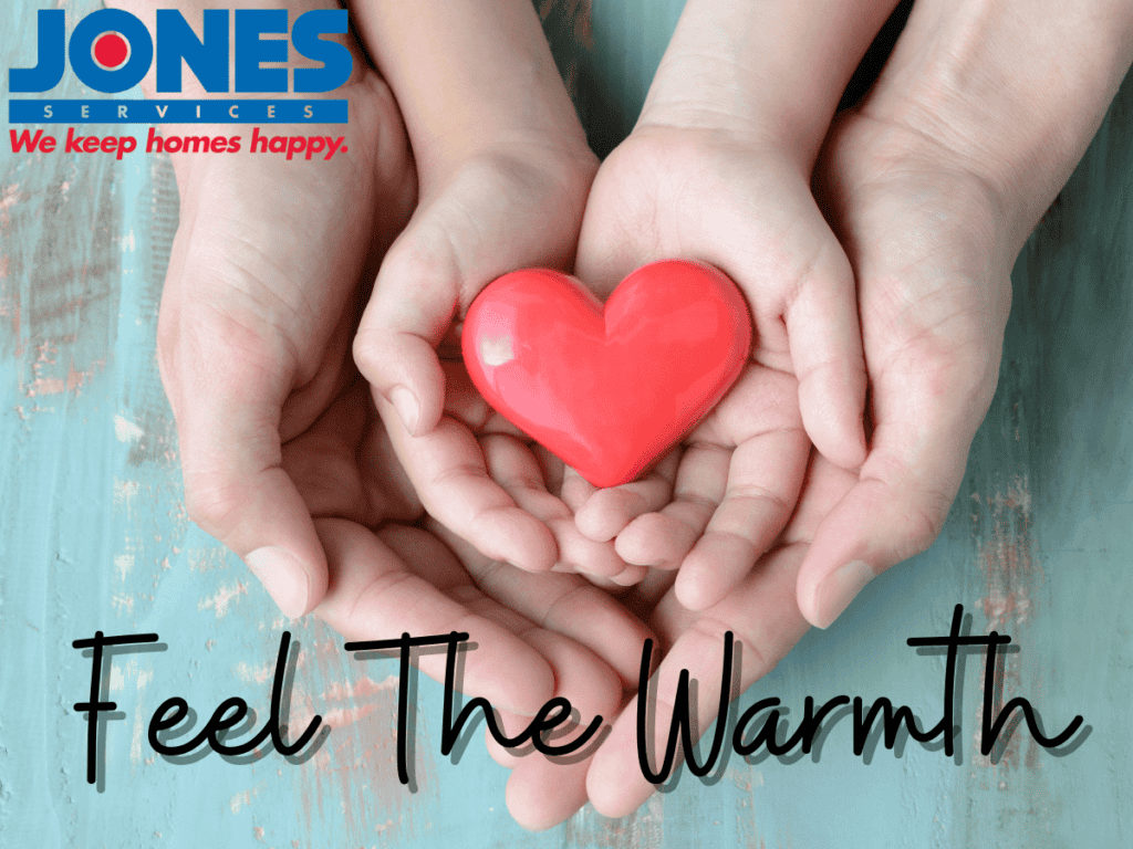 Two hands holding a smaller pair of hands, cradling a red heart-shaped object. Text reads, "Feel The Warmth" with a company logo at the top.